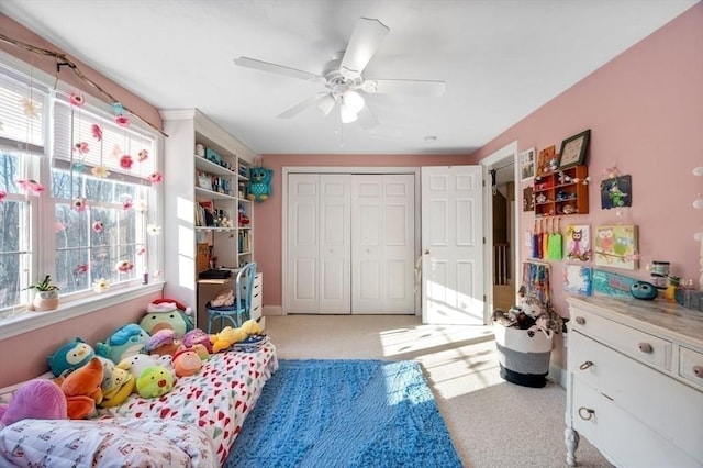 bedroom with light colored carpet, a closet, and ceiling fan
