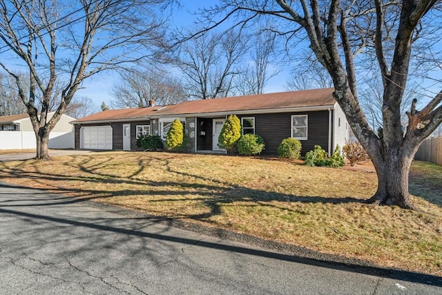 single story home with a front yard and a garage