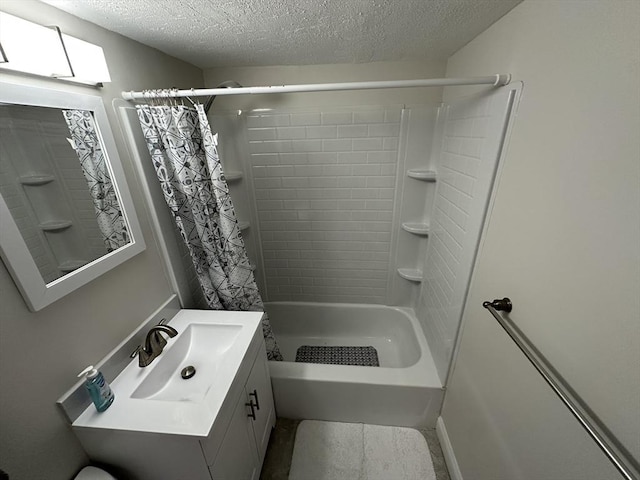 bathroom featuring a textured ceiling, shower / bath combo, and vanity