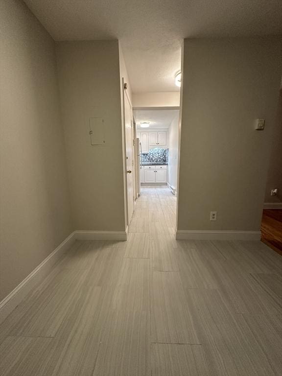 unfurnished room with baseboards