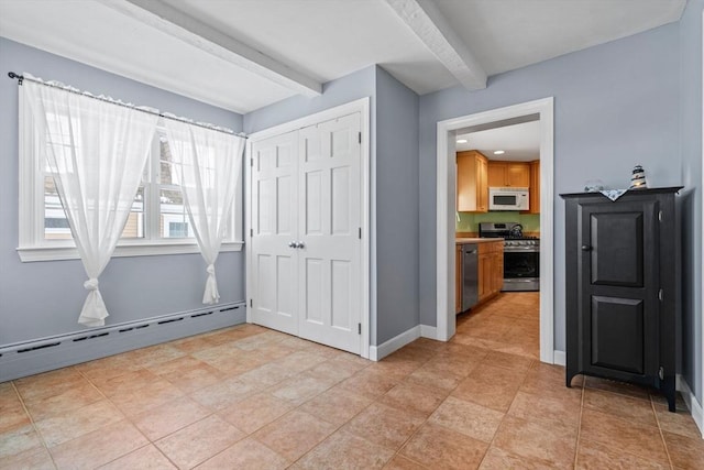 interior space with a baseboard radiator, beam ceiling, and a closet