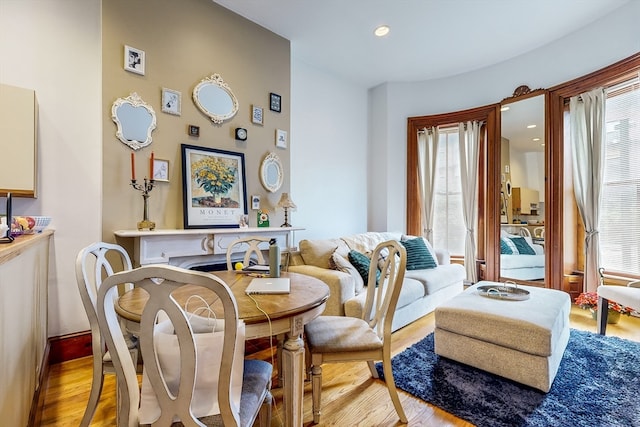 dining space with plenty of natural light and light hardwood / wood-style flooring