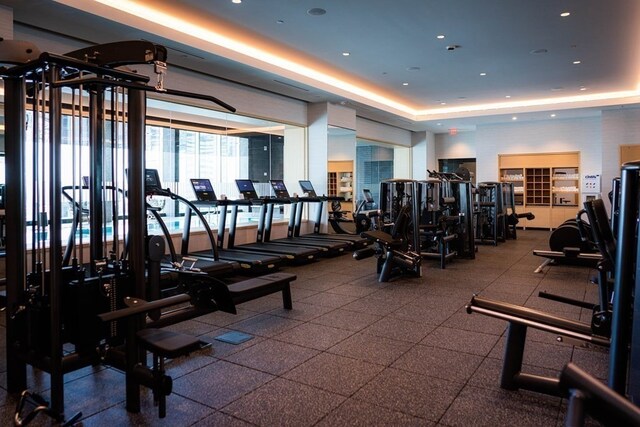 gym with a tray ceiling