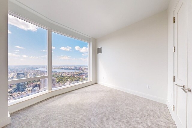 carpeted spare room with vaulted ceiling