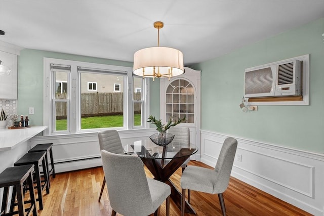 10 Highfield Ter, Boston, MA 02131 - dining room featuring wood finished floors, a chandelier, wainscoting, and a baseboard radiator