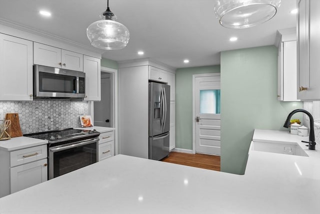 10 Highfield Ter, Boston, MA 02131 - kitchen featuring stainless steel appliances, tasteful backsplash, white cabinetry, light countertops, and recessed lighting