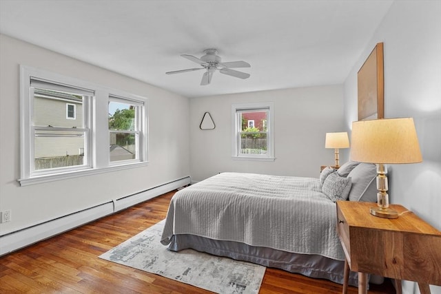 10 Highfield Ter, Boston, MA 02131 - bedroom featuring multiple windows, a baseboard heating unit, and wood finished floors