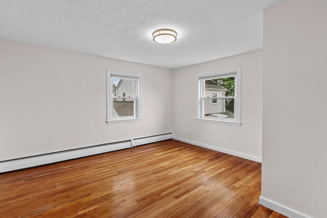 10 Highfield Ter, Boston, MA 02131 - empty room with light wood-style flooring and a baseboard radiator