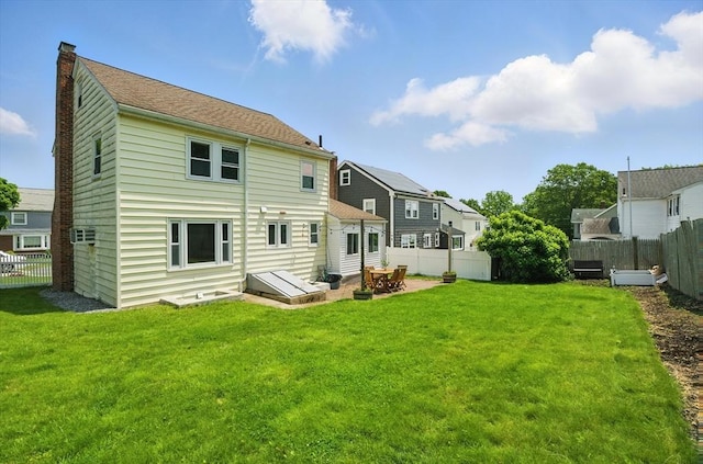 10 Highfield Ter, Boston, MA 02131 - back of property featuring a fenced backyard, a chimney, a patio, and a residential view