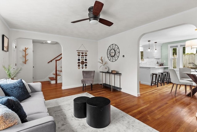 10 Highfield Ter, Boston, MA 02131 - living area featuring arched walkways, wood finished floors, a ceiling fan, stairway, and crown molding