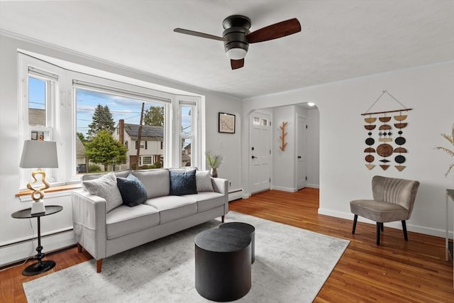 10 Highfield Ter, Boston, MA 02131 - living area with ceiling fan, a baseboard heating unit, arched walkways, wood finished floors, and crown molding