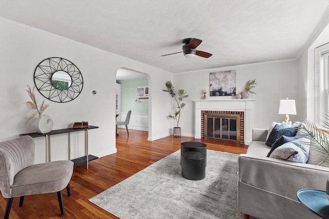 10 Highfield Ter, Boston, MA 02131 - living room featuring arched walkways, wood finished floors, ceiling fan, crown molding, and a brick fireplace