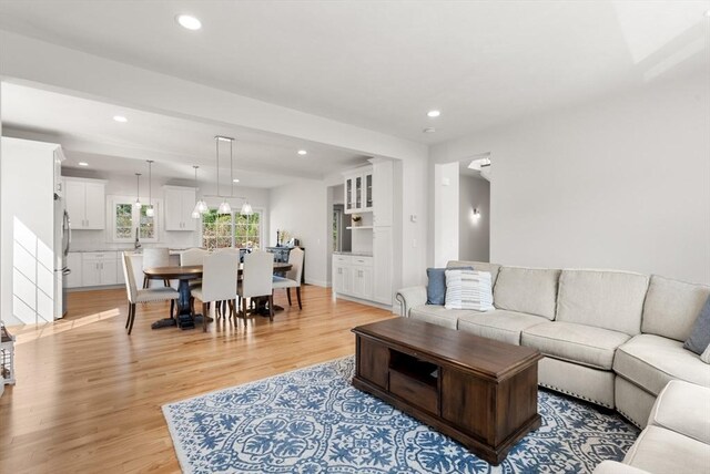 living area with recessed lighting and light wood finished floors