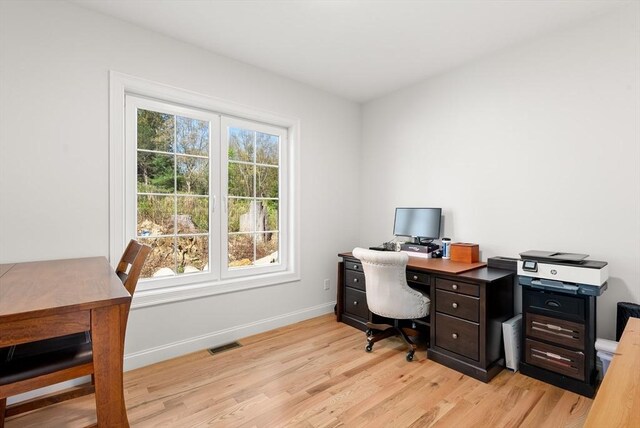 office with visible vents, light wood-style floors, and baseboards