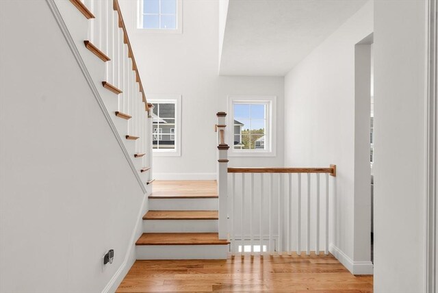 stairs featuring baseboards and wood finished floors
