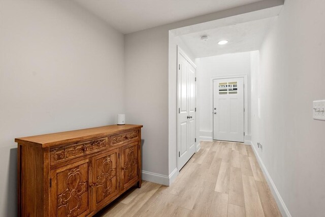 hallway featuring recessed lighting, baseboards, and light wood finished floors