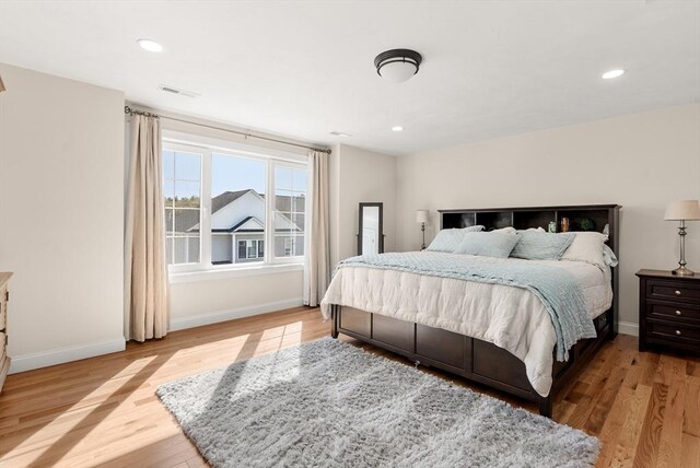 bedroom with visible vents, recessed lighting, baseboards, and light wood-type flooring