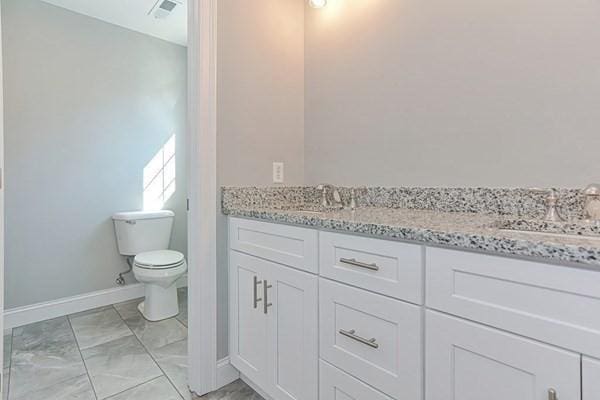 bathroom featuring vanity and toilet