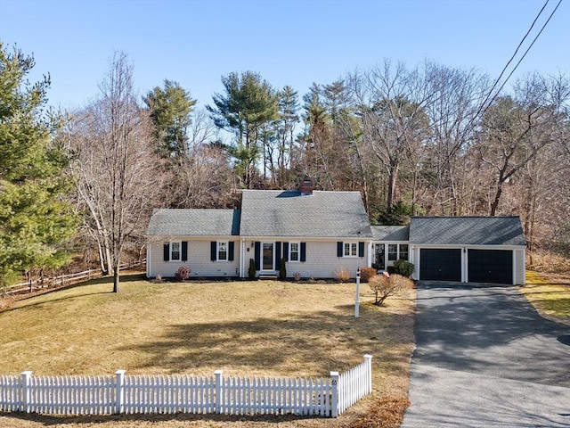 ranch-style house with a front lawn, driveway, a garage, and a fenced front yard