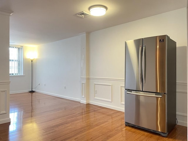 kitchen with freestanding refrigerator and light wood-type flooring