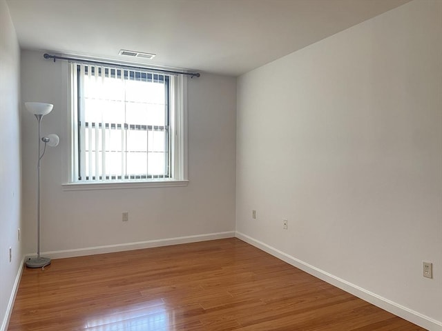 empty room with wood finished floors and baseboards
