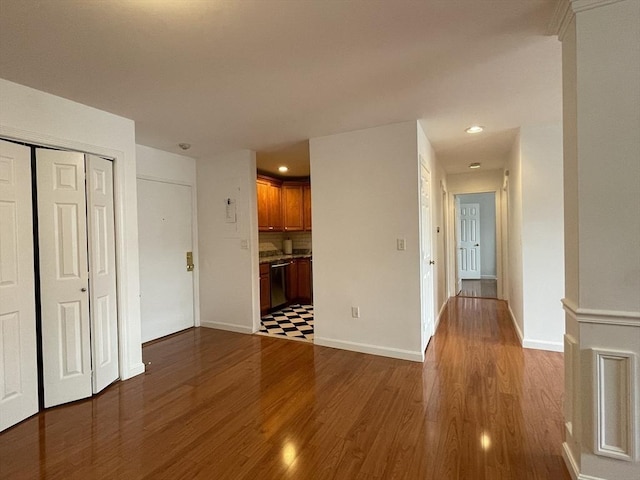unfurnished living room featuring dark wood finished floors, recessed lighting, and baseboards
