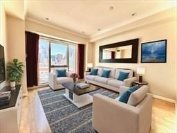 living room featuring hardwood / wood-style flooring and crown molding