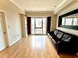 living room featuring crown molding and light hardwood / wood-style floors