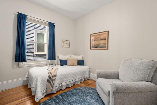 bedroom featuring baseboards and wood finished floors