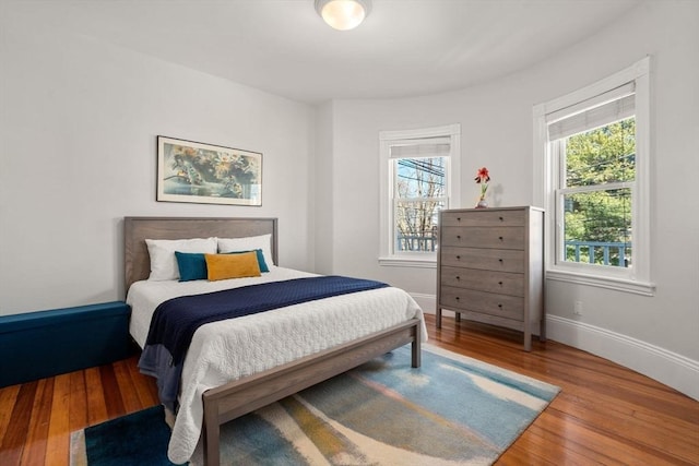 bedroom with hardwood / wood-style floors and baseboards