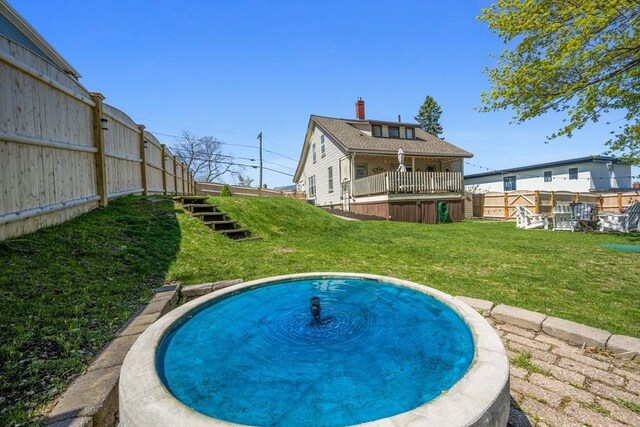 back of property featuring a lawn and fence