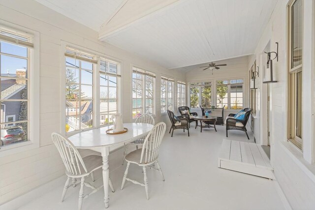 sunroom featuring finished concrete flooring, vaulted ceiling, and wood ceiling