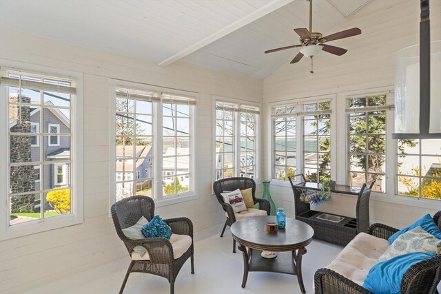 sunroom / solarium featuring lofted ceiling and a healthy amount of sunlight