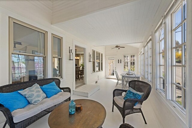 sunroom with an outdoor living space, a ceiling fan, and plenty of natural light