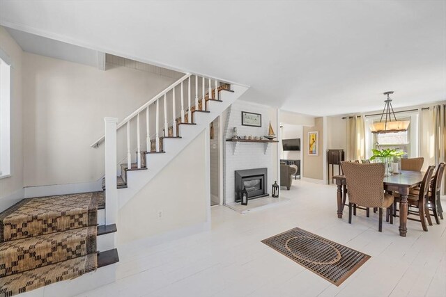 dining room with baseboards and stairway