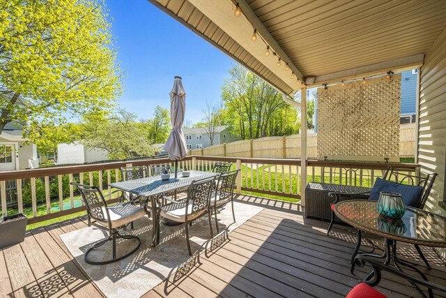 wooden deck featuring fence and outdoor dining space