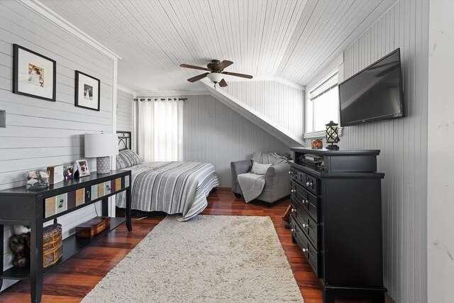 bedroom with a ceiling fan, wood walls, dark wood-style floors, and wood ceiling