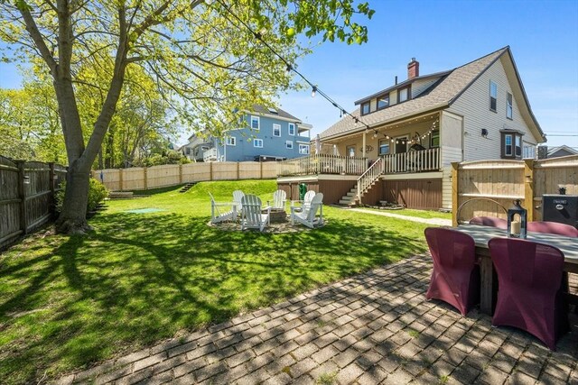 view of yard featuring stairway, a patio, a fenced backyard, and an outdoor fire pit