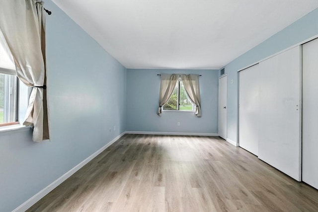 49 Village Brook Ln Unit 2, Natick, MA 01760 - unfurnished bedroom with wood finished floors and a closet
