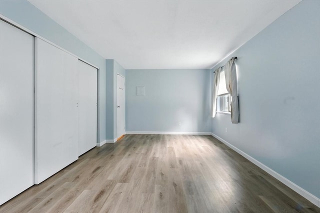 49 Village Brook Ln Unit 2, Natick, MA 01760 - unfurnished bedroom featuring wood finished floors and a closet