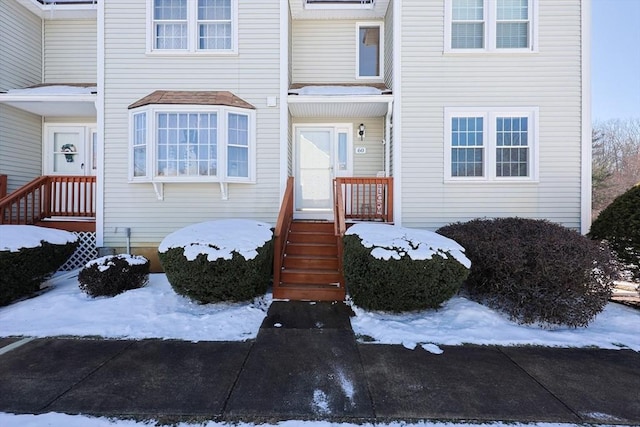 view of snow covered property entrance