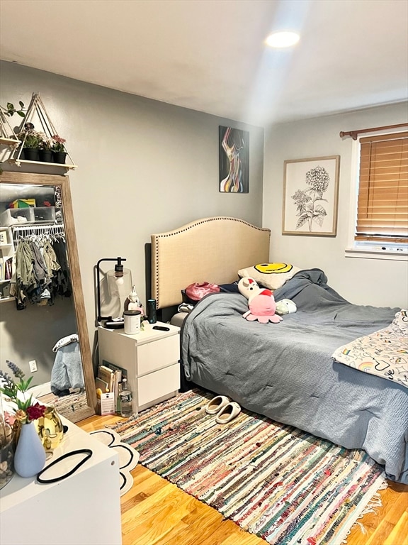 bedroom featuring hardwood / wood-style flooring and a closet