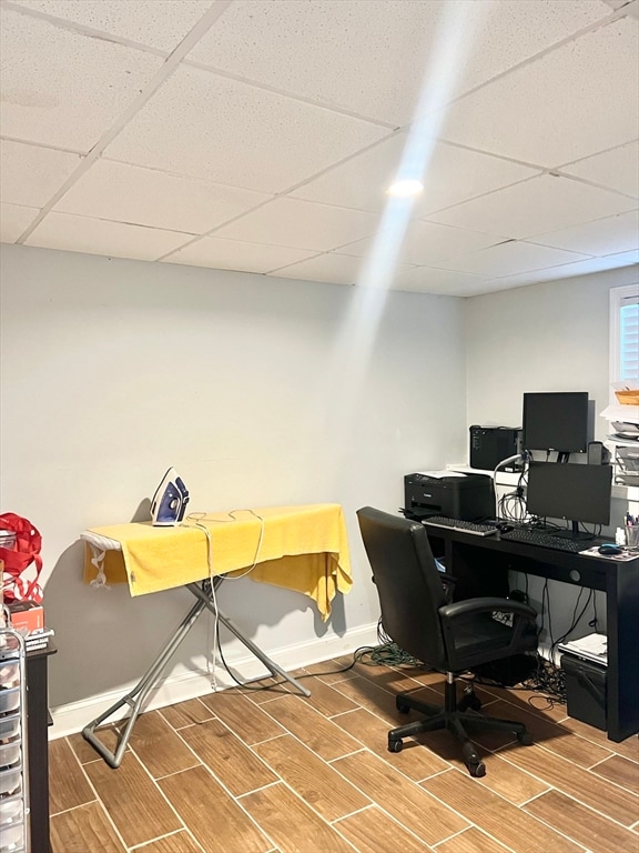 office area featuring wood-type flooring and a drop ceiling