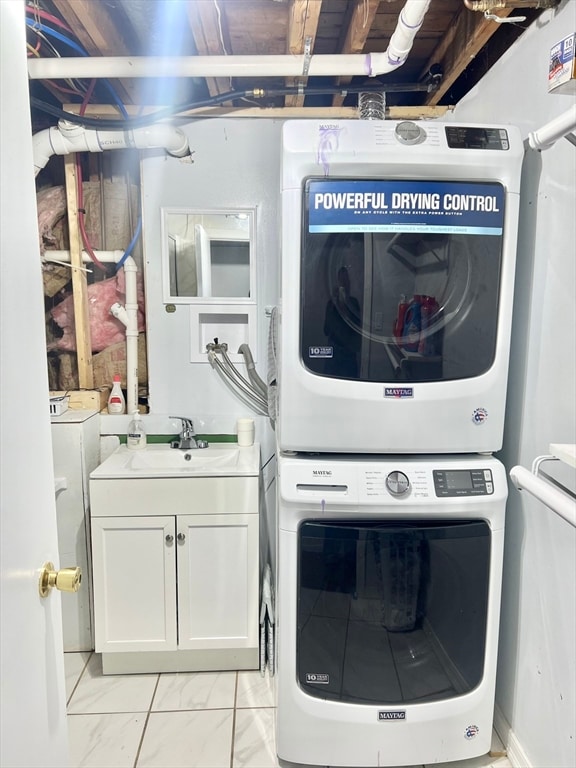 laundry area with stacked washing maching and dryer