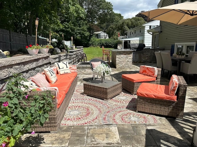 view of patio / terrace with exterior kitchen and an outdoor hangout area