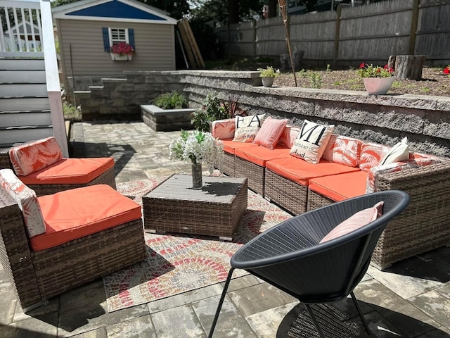 view of patio with a shed and outdoor lounge area