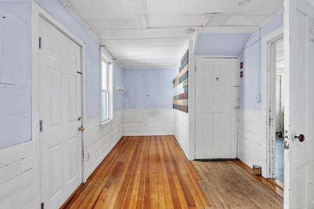 entrance foyer featuring wood-type flooring and a wainscoted wall