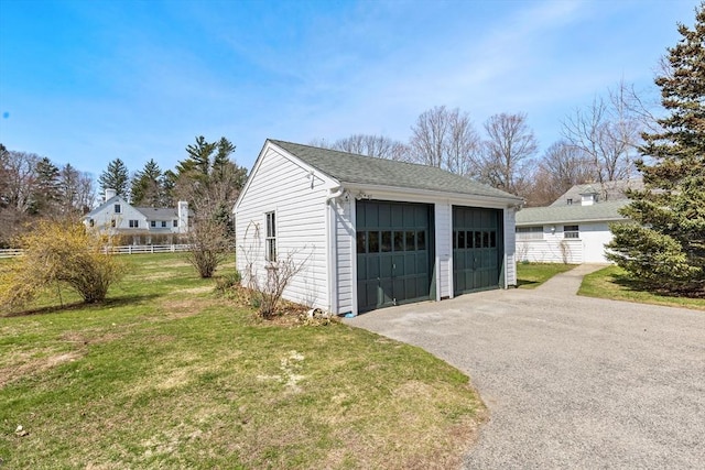 detached garage featuring fence
