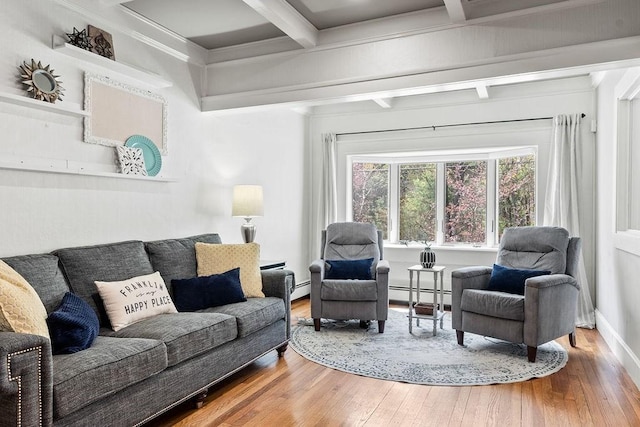 living area featuring wood-type flooring, ornamental molding, beam ceiling, and baseboard heating
