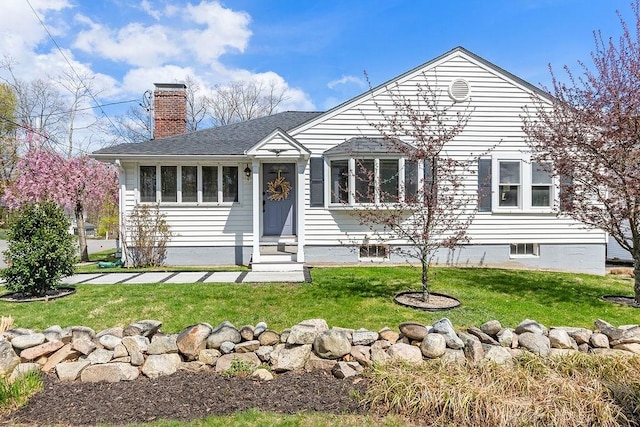 single story home with a front yard, a chimney, a shingled roof, and entry steps